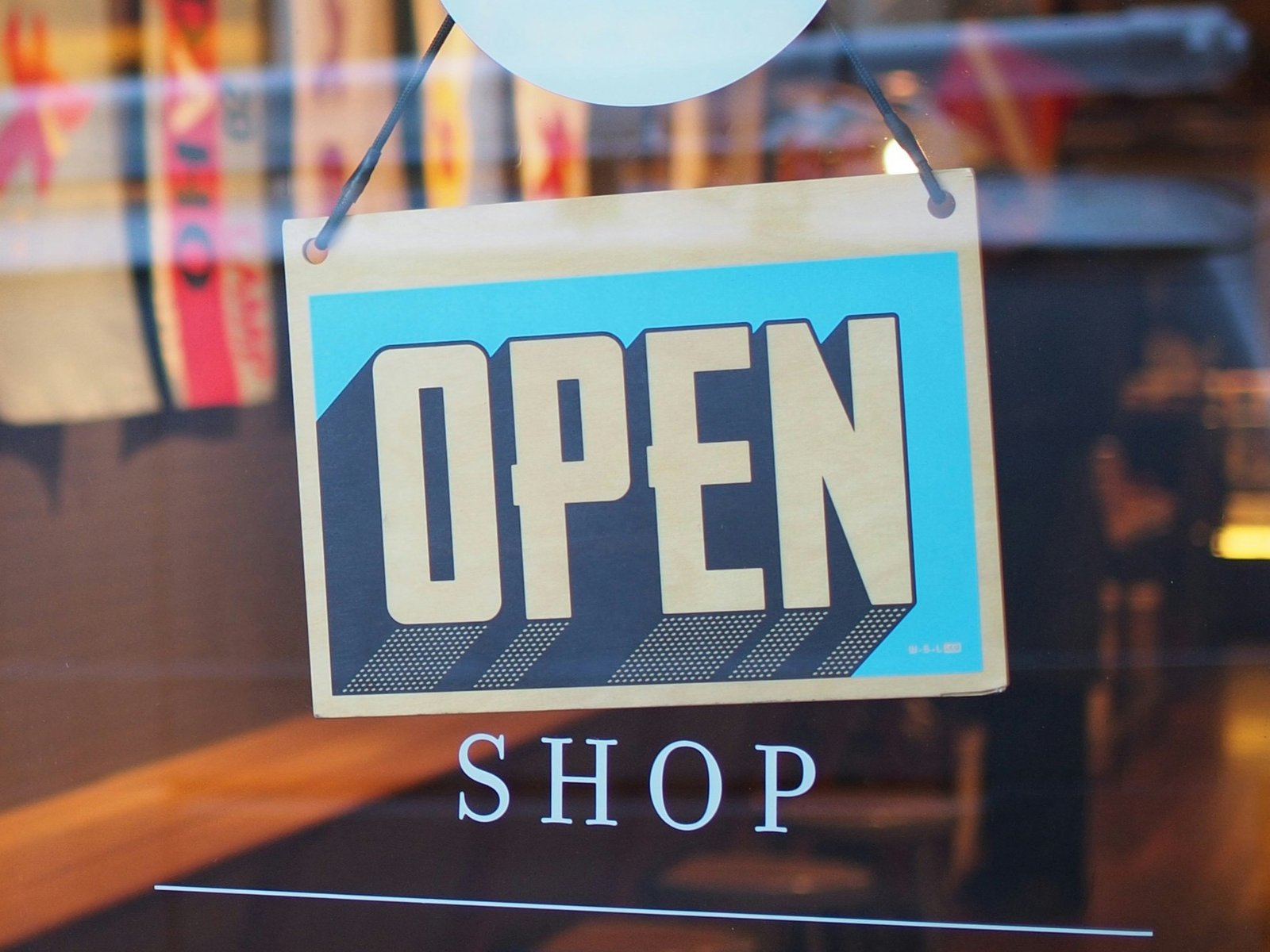 Open shop sign in a store as SAP and Google Cloud are deploying agentic commerce architecture to automate multi-agent marketing and retail operations at enterprise scale.